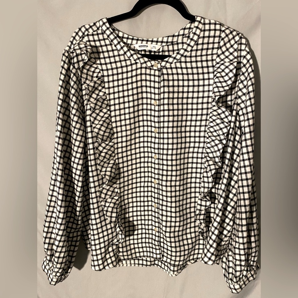 Fun black and white checkered flannel top with ruffles!